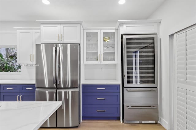 3229 Canal Dr, Pompano Beach, FL 33062 - kitchen featuring freestanding refrigerator, wine cooler, white cabinets, and recessed lighting