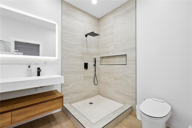 3229 Canal Dr, Pompano Beach, FL 33062 - bathroom with a tile shower, vanity, wood finished floors, and recessed lighting