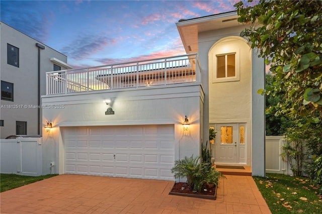 3229 Canal Dr, Pompano Beach, FL 33062 - view of front of property featuring a balcony, decorative driveway, stucco siding, and an attached garage