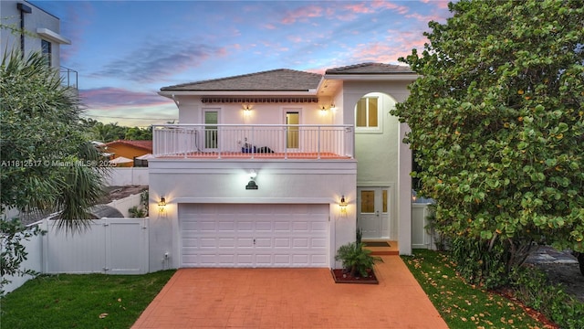 3229 Canal Dr, Pompano Beach, FL 33062 - view of front of house with a balcony, decorative driveway, stucco siding, and an attached garage