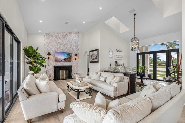 9291 SW 88th St, Miami, FL 33176 - living room with high vaulted ceiling, a chandelier, light wood-type flooring, recessed lighting, and a skylight