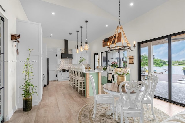 9291 SW 88th St, Miami, FL 33176 - dining space with a chandelier, light wood finished floors, recessed lighting, and a towering ceiling