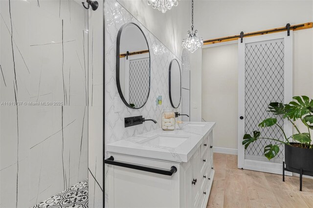9291 SW 88th St, Miami, FL 33176 - bathroom with double vanity, wood finished floors, a shower, a chandelier, and baseboards