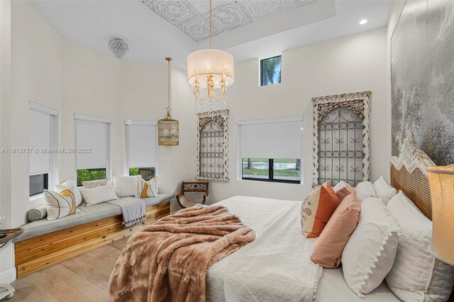 9291 SW 88th St, Miami, FL 33176 - bedroom featuring a towering ceiling, multiple windows, wood finished floors, a chandelier, and recessed lighting