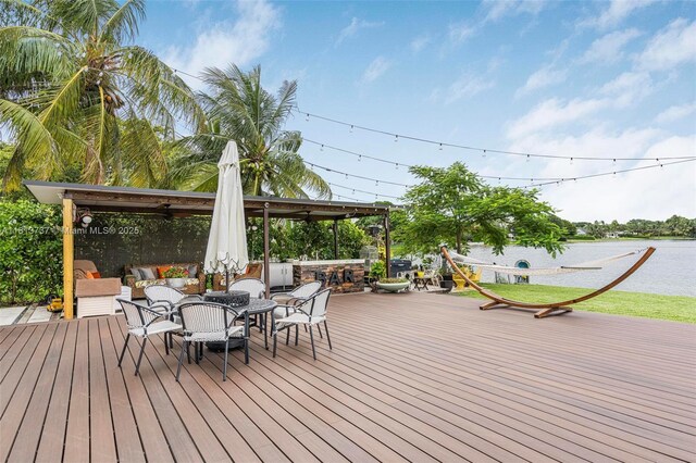 9291 SW 88th St, Miami, FL 33176 - wooden deck with a water view and outdoor dining area