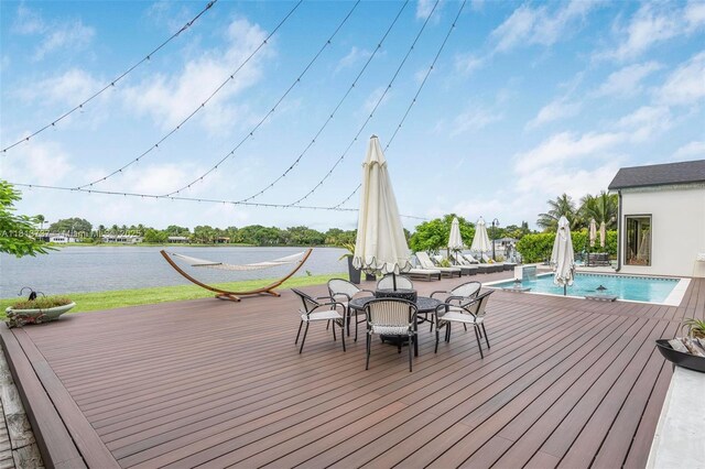 9291 SW 88th St, Miami, FL 33176 - wooden terrace featuring an outdoor pool, a water view, and outdoor dining space