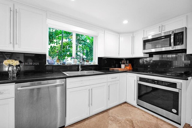 1450 Ortega Ave, Coral Gables, FL 33134 - kitchen with appliances with stainless steel finishes, backsplash, dark countertops, and recessed lighting