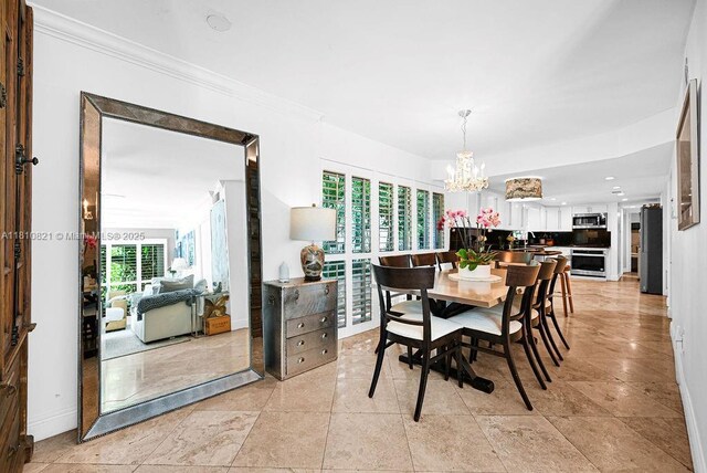 1450 Ortega Ave, Coral Gables, FL 33134 - dining area with a chandelier, baseboards, and ornamental molding