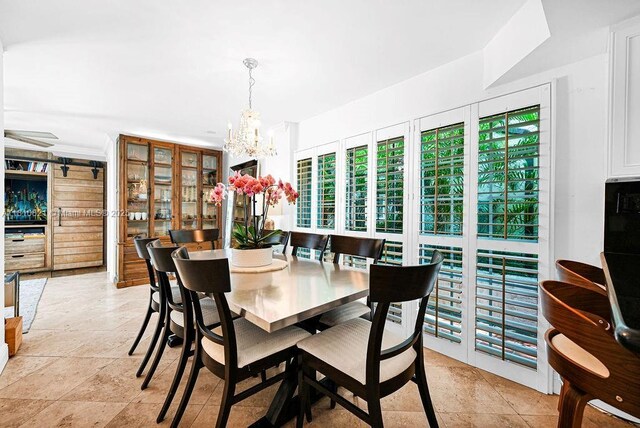 1450 Ortega Ave, Coral Gables, FL 33134 - dining space featuring a chandelier and stone tile flooring