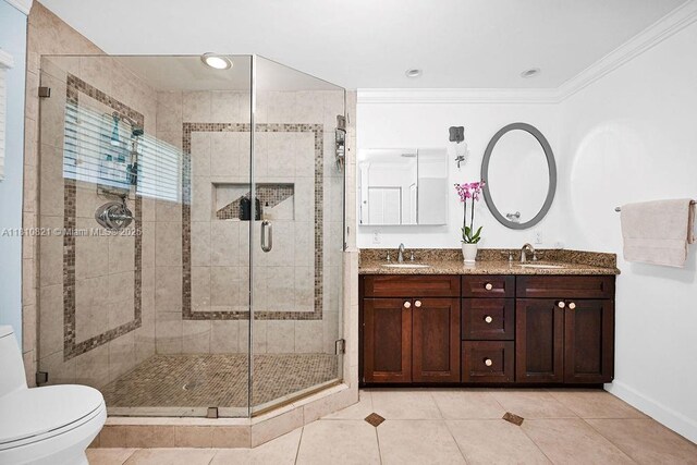 1450 Ortega Ave, Coral Gables, FL 33134 - full bath with toilet, double vanity, ornamental molding, tile patterned flooring, and a stall shower