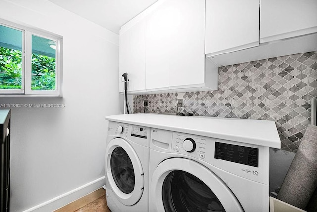 1450 Ortega Ave, Coral Gables, FL 33134 - laundry room with cabinet space, washing machine and dryer, and baseboards