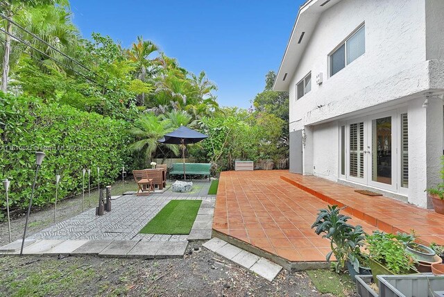1450 Ortega Ave, Coral Gables, FL 33134 - view of patio featuring french doors