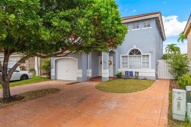 14011 SW 151st Ave, Miami, FL 33196 - view of front of house with stucco siding, decorative driveway, an attached garage, and a gate