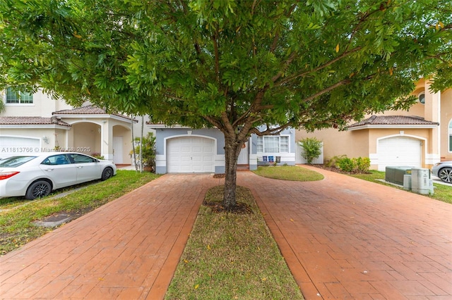 14011 SW 151st Ave, Miami, FL 33196 - view of front of home with decorative driveway, a garage, stucco siding, and a tile roof