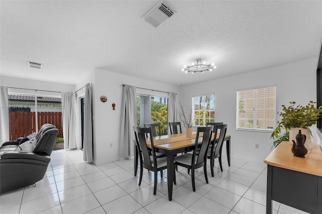 14011 SW 151st Ave, Miami, FL 33196 - dining area featuring a chandelier, light tile patterned floors, and a textured ceiling