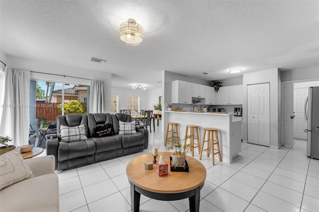 14011 SW 151st Ave, Miami, FL 33196 - living area featuring a textured ceiling and light tile patterned floors