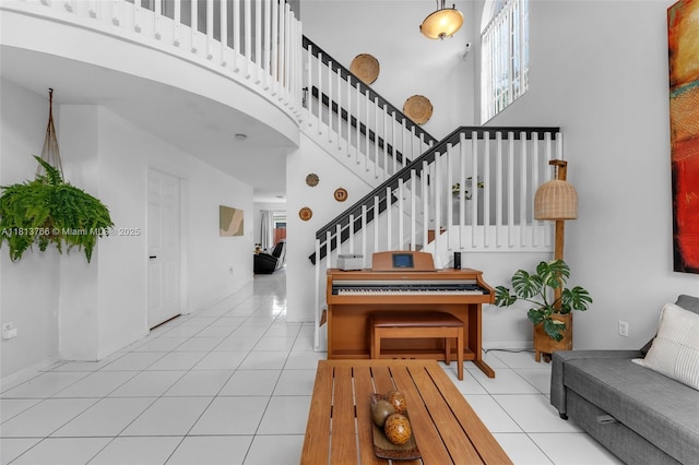 14011 SW 151st Ave, Miami, FL 33196 - entryway featuring tile patterned flooring, stairs, a high ceiling, and baseboards