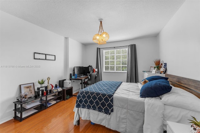 14011 SW 151st Ave, Miami, FL 33196 - bedroom featuring wood finished floors, an office area, and a chandelier