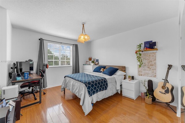 14011 SW 151st Ave, Miami, FL 33196 - bedroom with light wood-type flooring, an office area, baseboards, and a textured ceiling