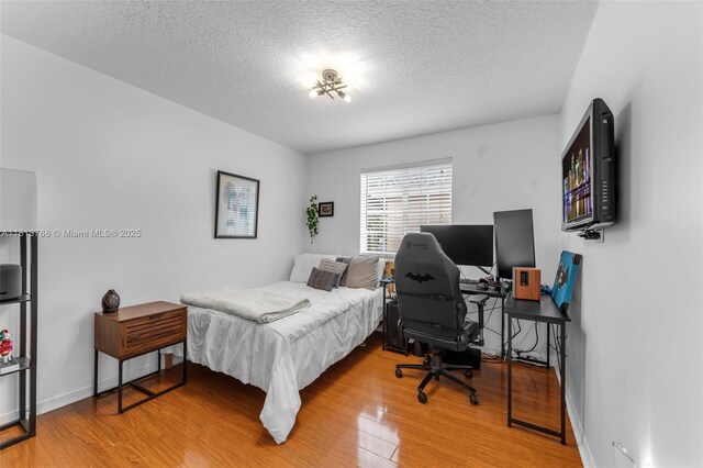 14011 SW 151st Ave, Miami, FL 33196 - bedroom with wood finished floors, a textured ceiling, an office area, and baseboards