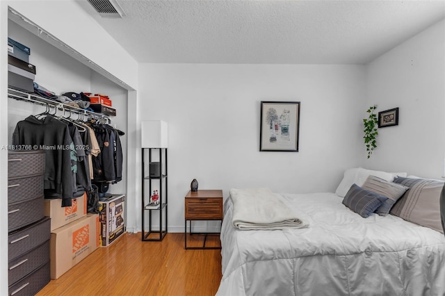 14011 SW 151st Ave, Miami, FL 33196 - bedroom featuring light wood-type flooring, a closet, and a textured ceiling