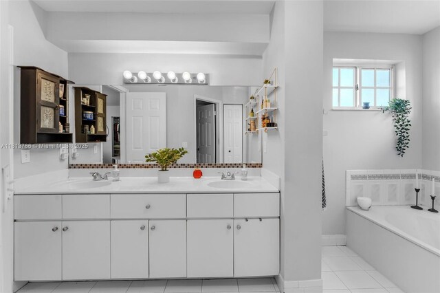 14011 SW 151st Ave, Miami, FL 33196 - full bathroom featuring double vanity, a garden tub, tile patterned floors, and baseboards