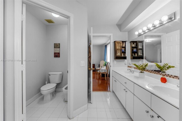 14011 SW 151st Ave, Miami, FL 33196 - bathroom featuring connected bathroom, double vanity, tile patterned floors, baseboards, and toilet