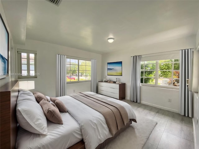 1201 S Biscayne Point Rd, Miami Beach, FL 33141 - bedroom with baseboards and light tile patterned flooring