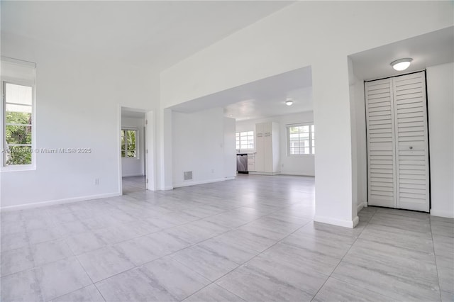 1201 S Biscayne Point Rd, Miami Beach, FL 33141 - unfurnished living room with light tile patterned floors and baseboards