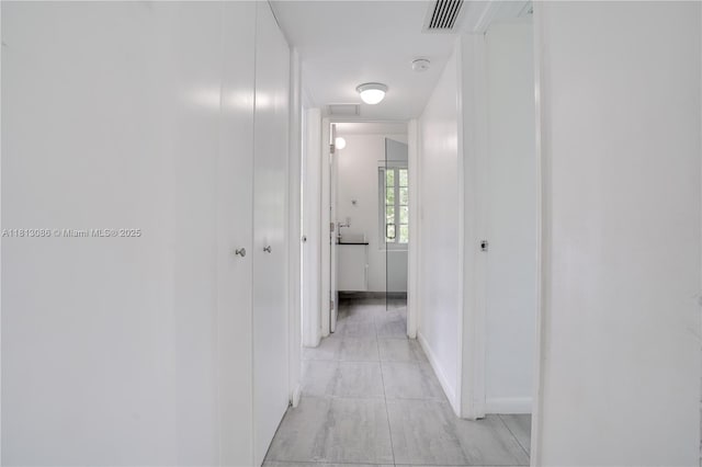 1201 S Biscayne Point Rd, Miami Beach, FL 33141 - corridor with light tile patterned floors and baseboards