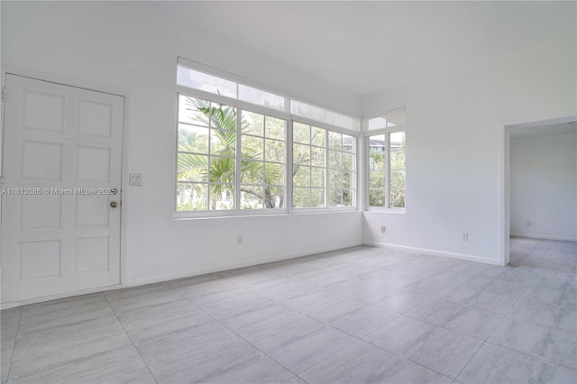 1201 S Biscayne Point Rd, Miami Beach, FL 33141 - tiled empty room with baseboards