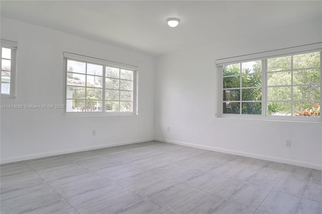 1201 S Biscayne Point Rd, Miami Beach, FL 33141 - tiled empty room with baseboards