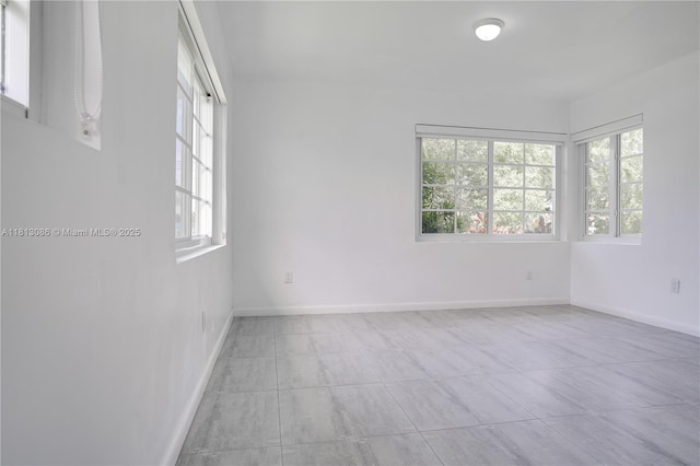 1201 S Biscayne Point Rd, Miami Beach, FL 33141 - tiled empty room with healthy amount of natural light and baseboards