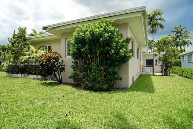 1201 S Biscayne Point Rd, Miami Beach, FL 33141 - view of property exterior with stucco siding and a yard