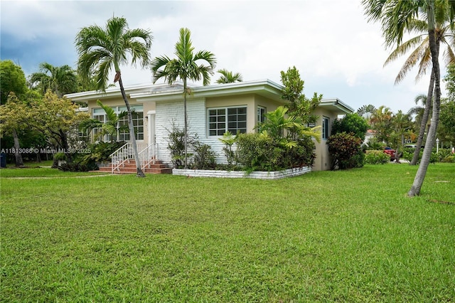 1201 S Biscayne Point Rd, Miami Beach, FL 33141 - view of side of property featuring a yard and stucco siding