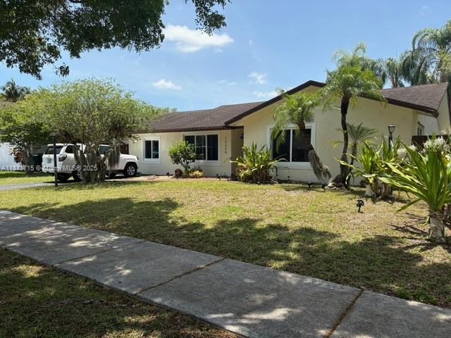 13324 SW 100th Ter, Miami, FL 33186 - ranch-style home with a front yard and stucco siding
