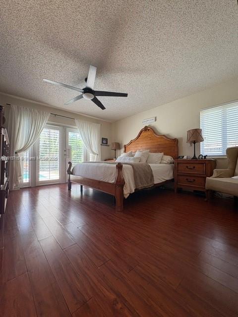 13324 SW 100th Ter, Miami, FL 33186 - bedroom with a textured ceiling, access to exterior, dark wood-style floors, and ceiling fan