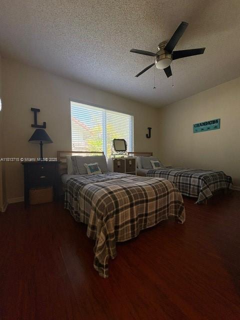 13324 SW 100th Ter, Miami, FL 33186 - bedroom with wood finished floors, a textured ceiling, ceiling fan, and baseboards