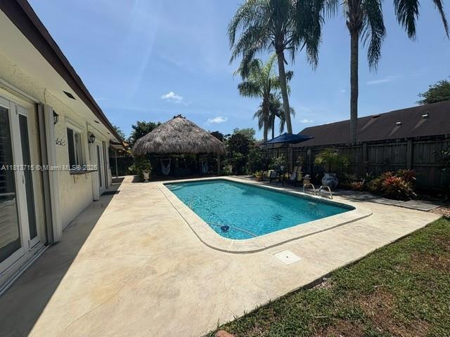 13324 SW 100th Ter, Miami, FL 33186 - view of pool with a fenced backyard and a patio