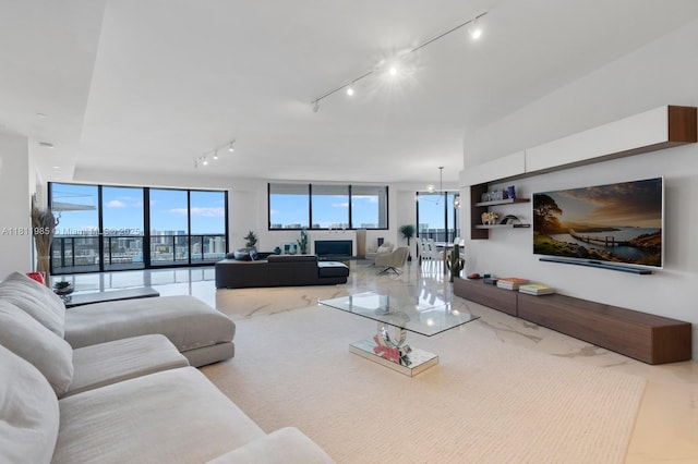 18555 Collins Ave Unit 1703, Sunny Isles Beach, FL 33160 - living area featuring rail lighting and marble finish flooring