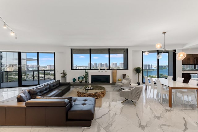 18555 Collins Ave Unit 1703, Sunny Isles Beach, FL 33160 - living area featuring track lighting, marble finish flooring, a water view, and a view of city