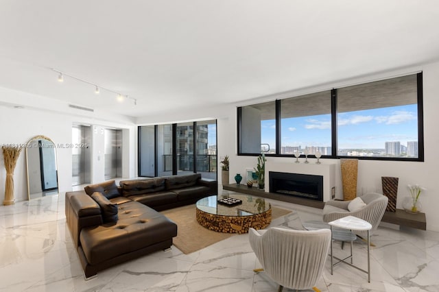 18555 Collins Ave Unit 1703, Sunny Isles Beach, FL 33160 - living area with a fireplace, light marble finish floors, and track lighting