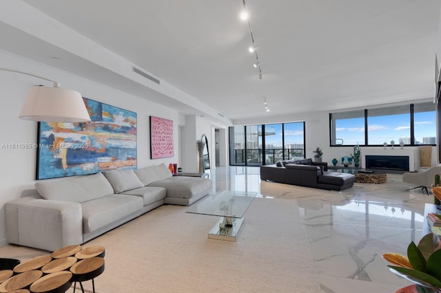 18555 Collins Ave Unit 1703, Sunny Isles Beach, FL 33160 - living area with marble tiled flooring, rail lighting, and a wall of windows