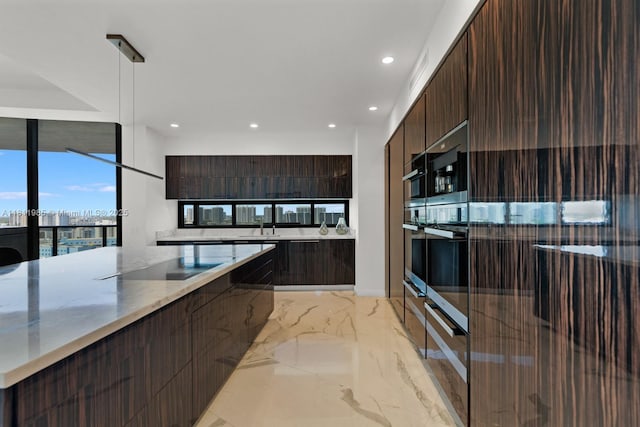 18555 Collins Ave Unit 1703, Sunny Isles Beach, FL 33160 - kitchen with modern cabinets, recessed lighting, light marble finish flooring, dark brown cabinetry, and stainless steel oven
