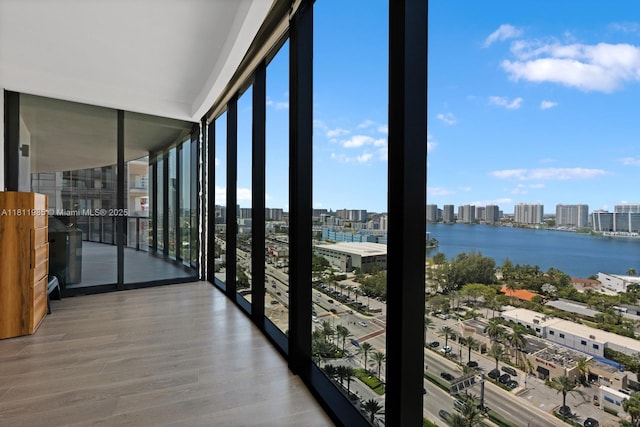 18555 Collins Ave Unit 1703, Sunny Isles Beach, FL 33160 - unfurnished sunroom featuring a skyline view, a water view, and healthy amount of natural light