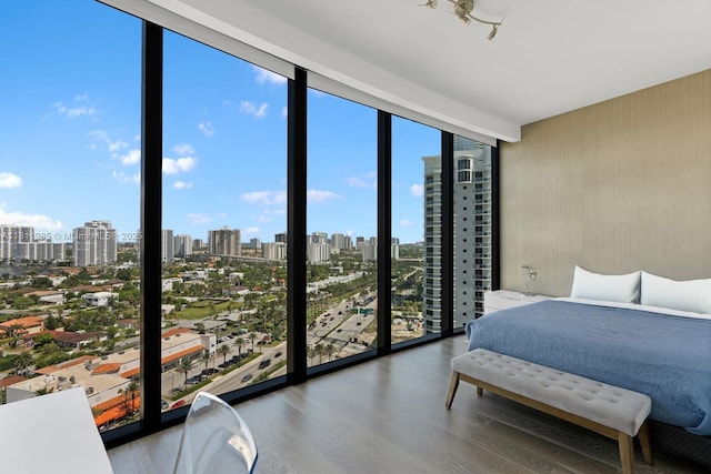 18555 Collins Ave Unit 1703, Sunny Isles Beach, FL 33160 - bedroom featuring floor to ceiling windows, a skyline view, and wood finished floors