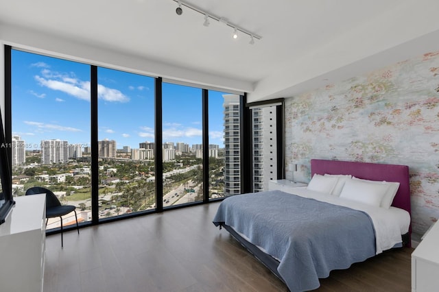 18555 Collins Ave Unit 1703, Sunny Isles Beach, FL 33160 - bedroom with expansive windows, rail lighting, wood finished floors, multiple windows, and a view of city
