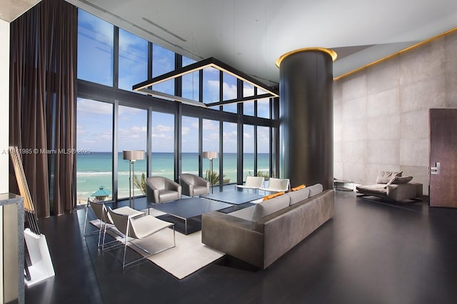 18555 Collins Ave Unit 1703, Sunny Isles Beach, FL 33160 - living room featuring expansive windows, a towering ceiling, plenty of natural light, and a water view