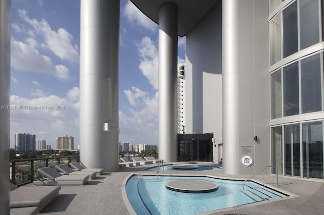 18555 Collins Ave Unit 1703, Sunny Isles Beach, FL 33160 - community pool featuring a hot tub and a view of city
