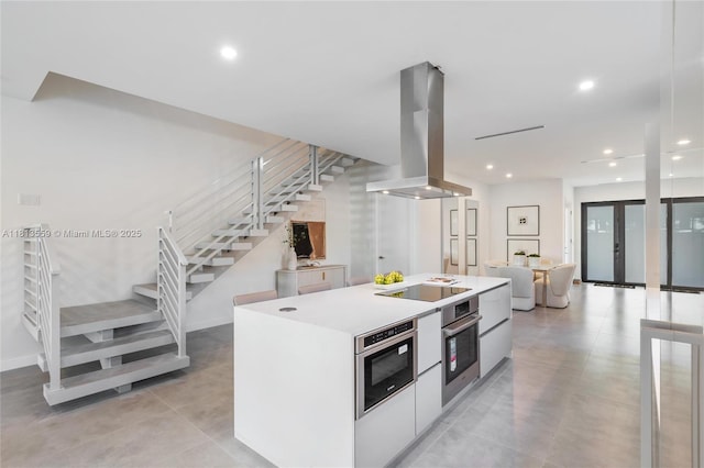 1201 SW 23rd St Right, Unit Right, Miami, FL 33145 - kitchen with modern cabinets, island exhaust hood, stainless steel oven, black electric cooktop, and a kitchen island